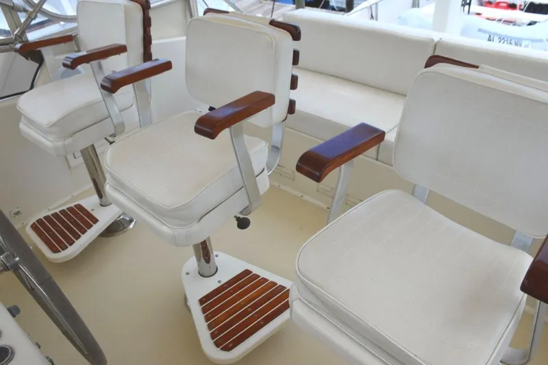 Qa3 Yacht Photos Pics Three teak ladderback chairs with arm and footrests.