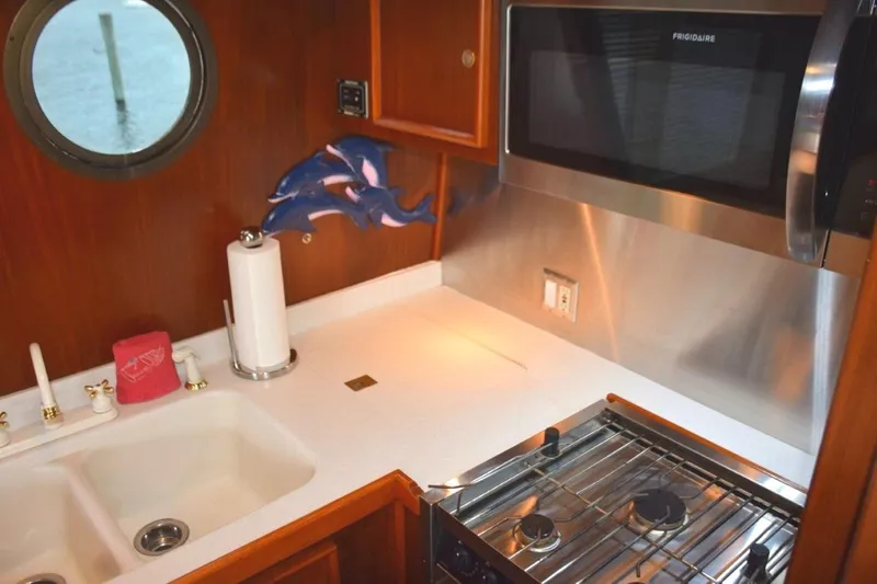 Qa3 Yacht Photos Pics Custom galley with molded countertop/sink and stainless appliances and splash panels