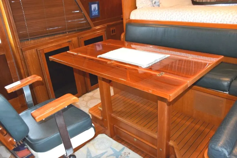 Qa3 Yacht Photos Pics Pilothouse table expanded and helm chair turned