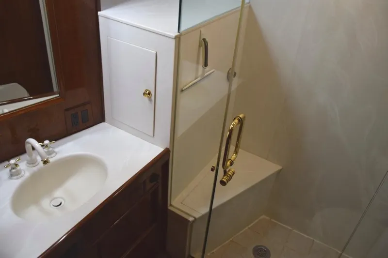 Qa3 Yacht Photos Pics Master vanity top with mirrored medicine cabinet and glass shower enclosure with seat.