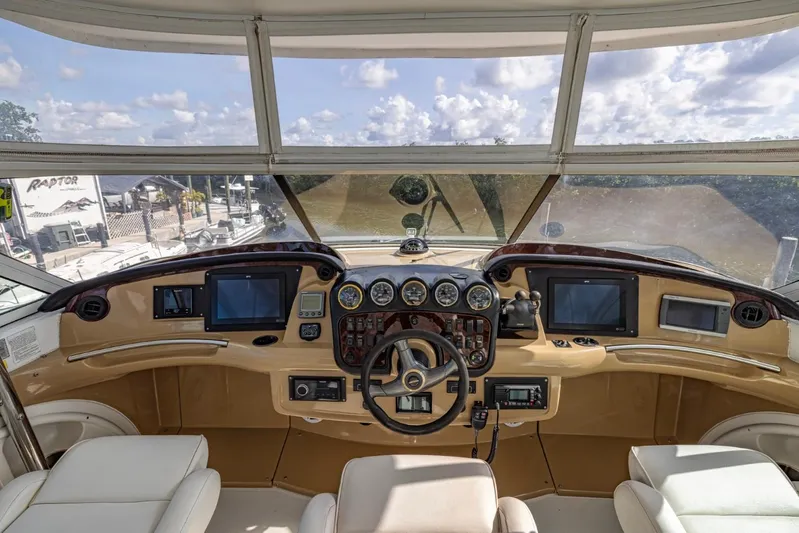 Paradise Yacht Photos Pics Helm of 2002 Carver 466 Motor Yacht with modern navigation equipment and panoramic view.