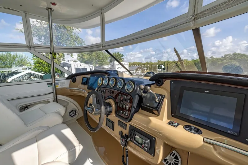 Paradise Yacht Photos Pics Interior helm of 2002 Carver 466 Motor Yacht with steering wheel and navigation instruments.