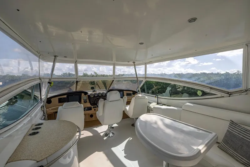 Paradise Yacht Photos Pics Interior of 2002 Carver 466 Motor Yacht with helm, seating, and panoramic windows.