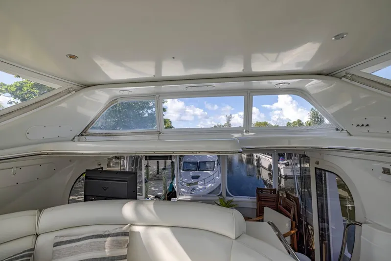 Paradise Yacht Photos Pics Interior view of 2002 Carver 466 Motor Yacht with large windows and comfortable seating.