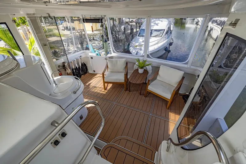 Paradise Yacht Photos Pics Luxurious 2002 Carver 466 Motor Yacht interior with seating area and scenic marina view.