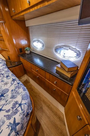 Paradise Yacht Photos Pics Luxurious 2002 Carver 466 Motor Yacht interior with wood cabinetry and nautical-themed bedding.