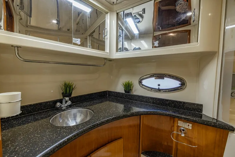 Paradise Yacht Photos Pics Luxurious bathroom in 2002 Carver 466 Motor Yacht with sleek countertop and mirror.
