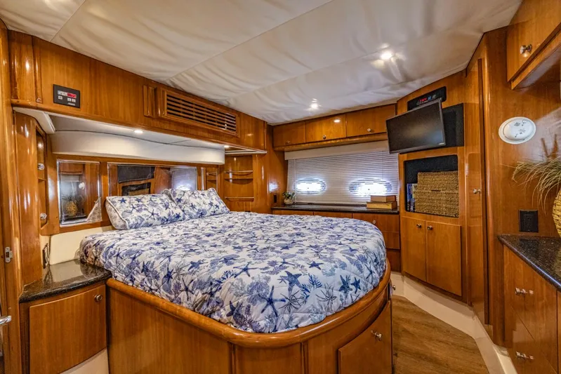 Paradise Yacht Photos Pics Luxurious 2002 Carver 466 Motor Yacht bedroom with wood cabinetry and floral bedding.