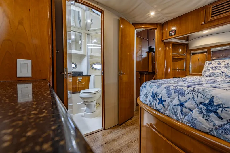 Paradise Yacht Photos Pics Interior of 2002 Carver 466 Motor Yacht with bedroom and bathroom, featuring wood finishes.