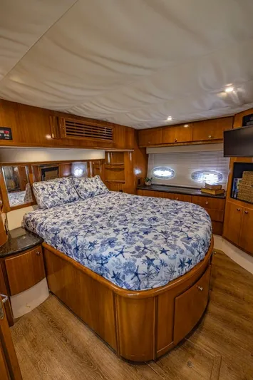 Paradise Yacht Photos Pics Luxurious bedroom in 2002 Carver 466 Motor Yacht with wood accents and nautical bedding.