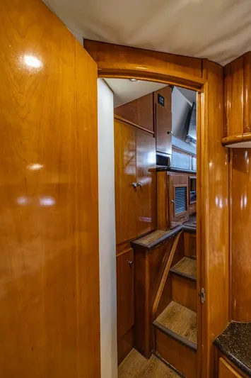Paradise Yacht Photos Pics Interior view of 2002 Carver 466 Motor Yacht with wooden cabinetry and stairs.