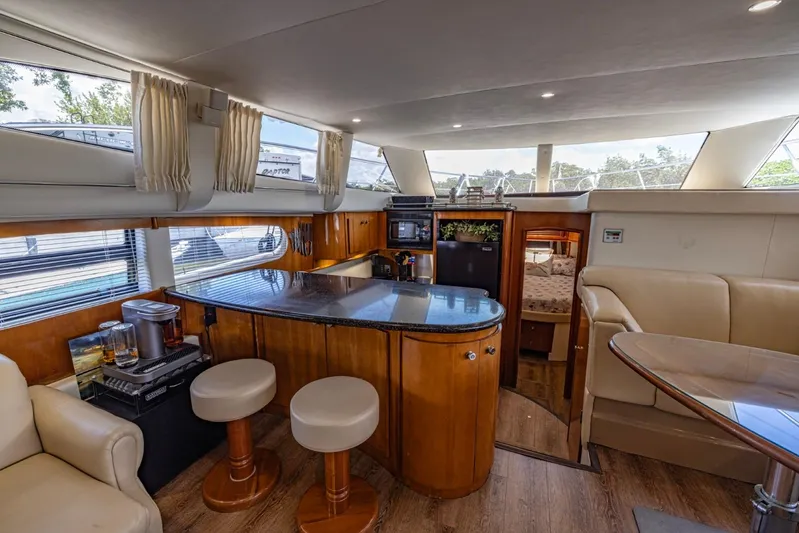 Paradise Yacht Photos Pics Luxurious interior of 2002 Carver 466 Motor Yacht with modern kitchen and seating area.
