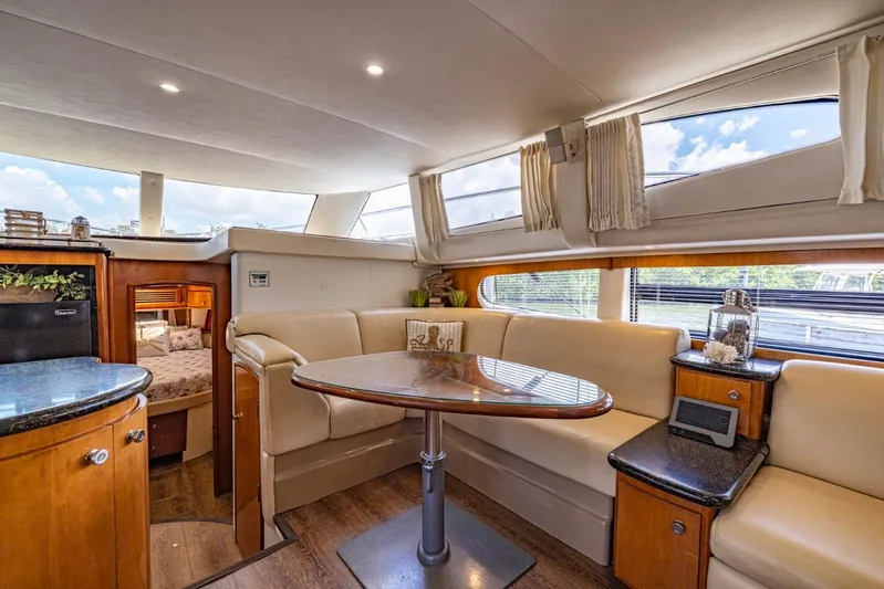 Paradise Yacht Photos Pics Luxurious interior of 2002 Carver 466 Motor Yacht with elegant seating and dining area.