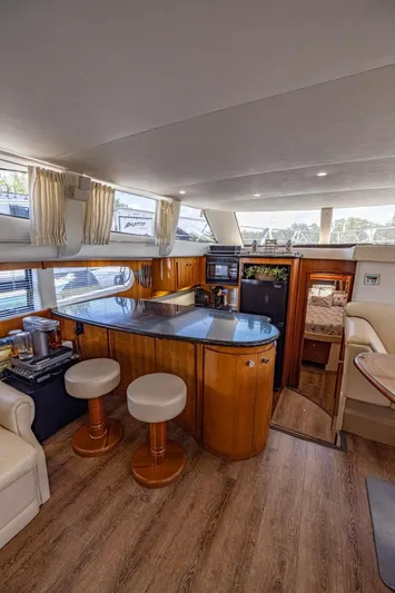 Paradise Yacht Photos Pics Luxurious interior of 2002 Carver 466 Motor Yacht with modern kitchen and seating area.
