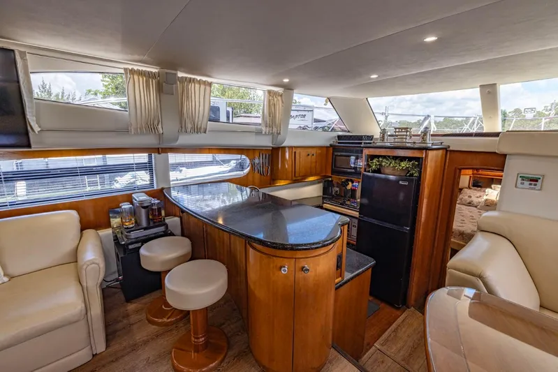 Paradise Yacht Photos Pics Luxurious interior of 2002 Carver 466 Motor Yacht with modern kitchen and seating area.