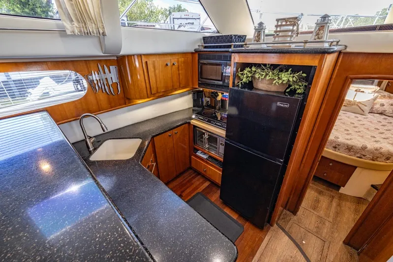 Paradise Yacht Photos Pics Luxurious kitchen interior of 2002 Carver 466 Motor Yacht with modern amenities.