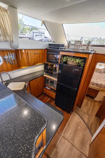 Paradise Yacht Photos Pics Interior of 2002 Carver 466 Motor Yacht with modern kitchen and wood accents.