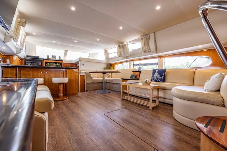 Paradise Yacht Photos Pics Luxurious interior of 2002 Carver 466 Motor Yacht with elegant seating and wooden flooring.