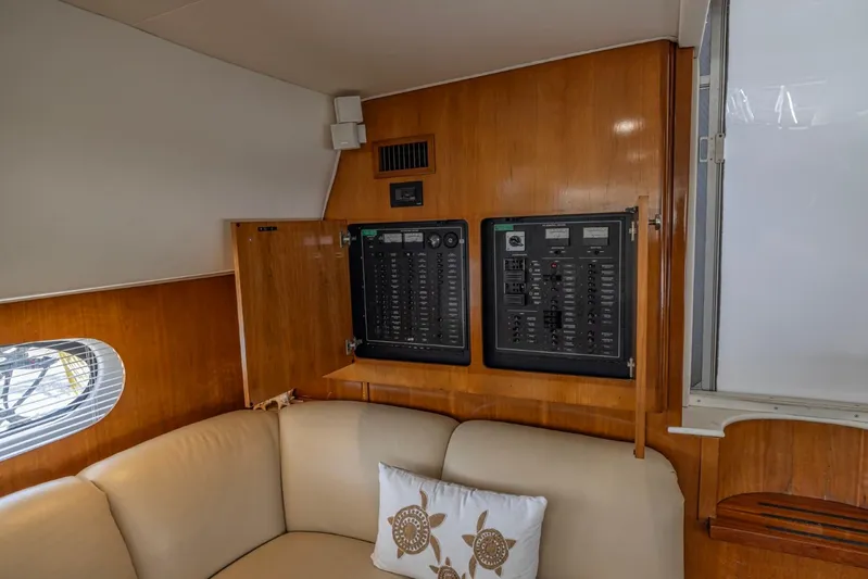 Paradise Yacht Photos Pics Interior of 2002 Carver 466 Motor Yacht with control panels and beige seating.