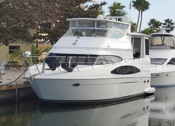 Paradise Yacht Photos Pics 2002 Carver 466 Motor Yacht docked near palm trees and waterfront.