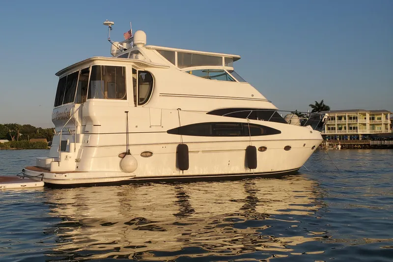 Paradise Yacht Photos Pics 2002 Carver 466 Motor Yacht on calm water at sunset, with scenic background.
