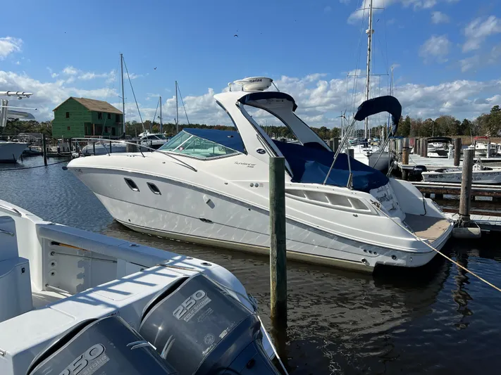 Vitamin Sea Yacht Photos Pics 2010 Sea Ray 330 Sundancer yacht docked at a marina under a clear blue sky.