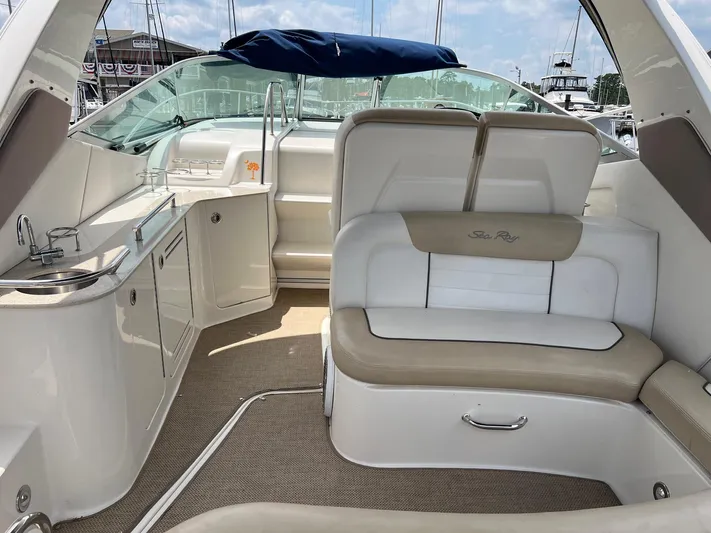 Vitamin Sea Yacht Photos Pics Interior of a 2010 Sea Ray 330 Sundancer boat with seating and kitchenette.