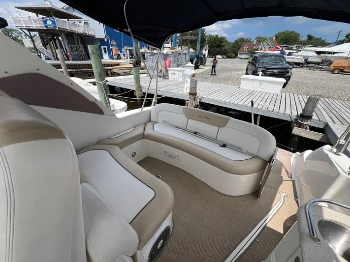 Vitamin Sea Yacht Photos Pics 2010 Sea Ray 330 Sundancer boat interior with beige seating at a marina dock.