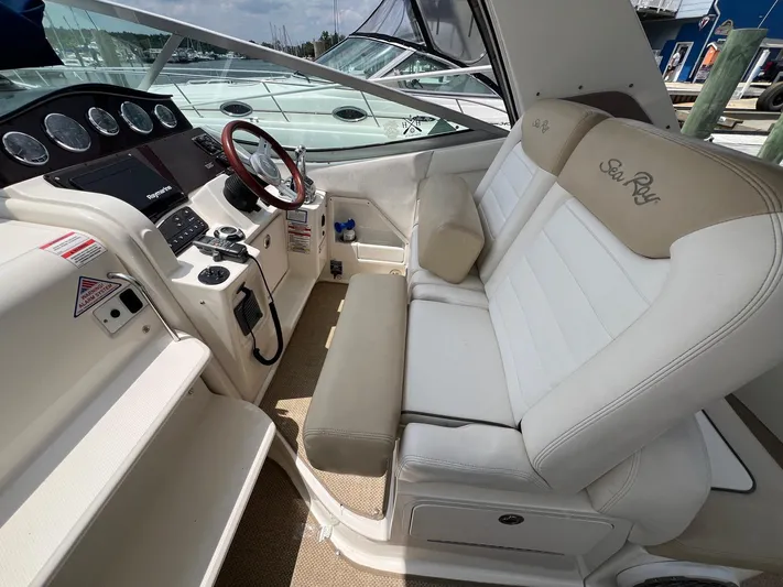 Vitamin Sea Yacht Photos Pics Interior of 2010 Sea Ray 330 Sundancer boat with steering wheel and seating.