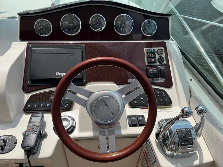 Vitamin Sea Yacht Photos Pics Control panel of a 2010 Sea Ray 330 Sundancer boat with steering wheel and gauges.