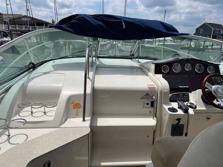 Vitamin Sea Yacht Photos Pics 2010 Sea Ray 330 Sundancer boat cockpit with steering wheel and control panel at marina.