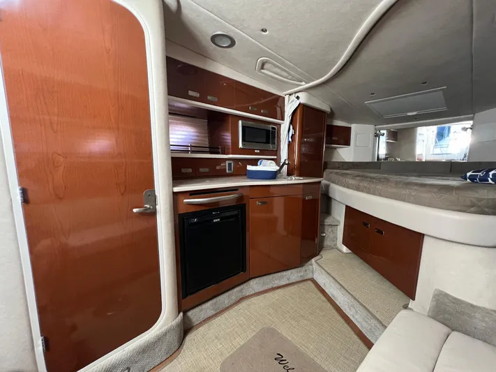 Vitamin Sea Yacht Photos Pics Interior of 2010 Sea Ray 330 Sundancer yacht with kitchenette and sleeping area.