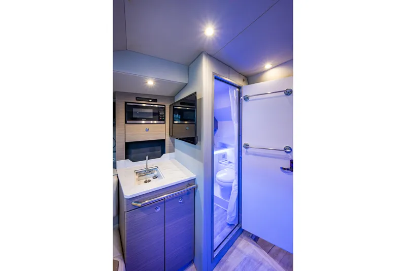  Yacht Photos Pics 2022 Formula 380 Super Sport Crossover OB interior with kitchenette and bathroom.