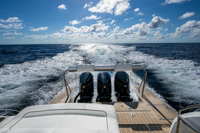  Yacht Photos Pics 2022 Formula 380 Super Sport Crossover OB cruising on open ocean under blue sky.