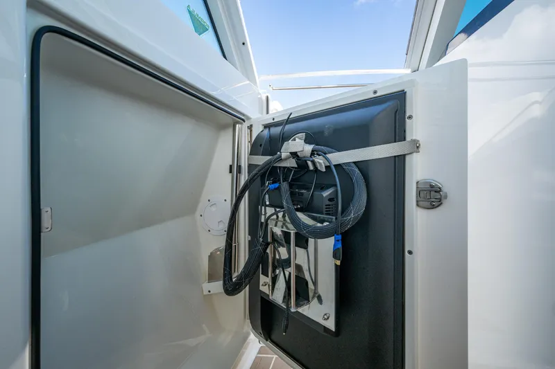  Yacht Photos Pics 2022 Formula 380 Super Sport Crossover OB storage compartment with cables and equipment.