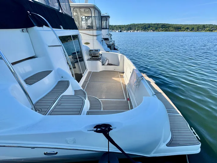  Yacht Photos Pics 2005 Meridian 459 CMY yacht docked on calm water, featuring spacious deck and seating area.