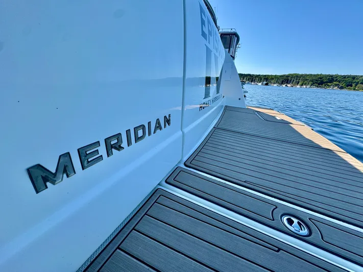  Yacht Photos Pics 2005 Meridian 459 CMY yacht on water, showcasing sleek design and branding.