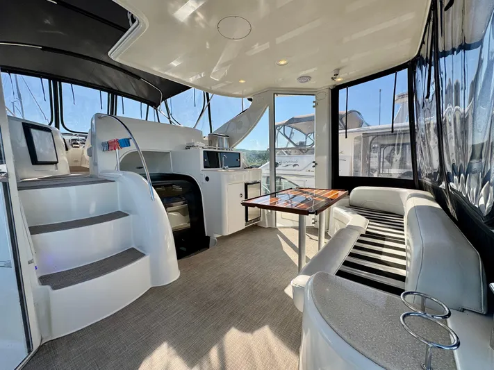  Yacht Photos Pics Interior of 2005 Meridian 459 CMY yacht with seating, table, and helm station.