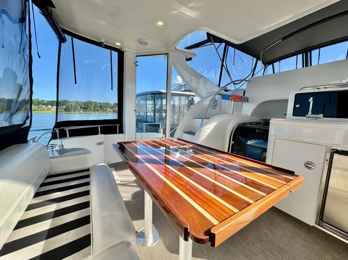  Yacht Photos Pics Luxurious 2005 Meridian 459 CMY yacht interior with elegant wood table and scenic water view.