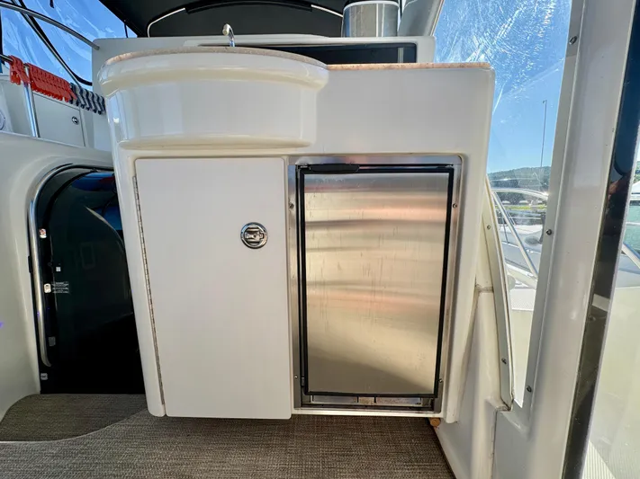  Yacht Photos Pics 2005 Meridian 459 CMY yacht interior with kitchenette and stainless steel fridge.