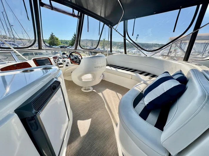  Yacht Photos Pics Luxurious interior of 2005 Meridian 459 CMY yacht with plush seating and modern helm.