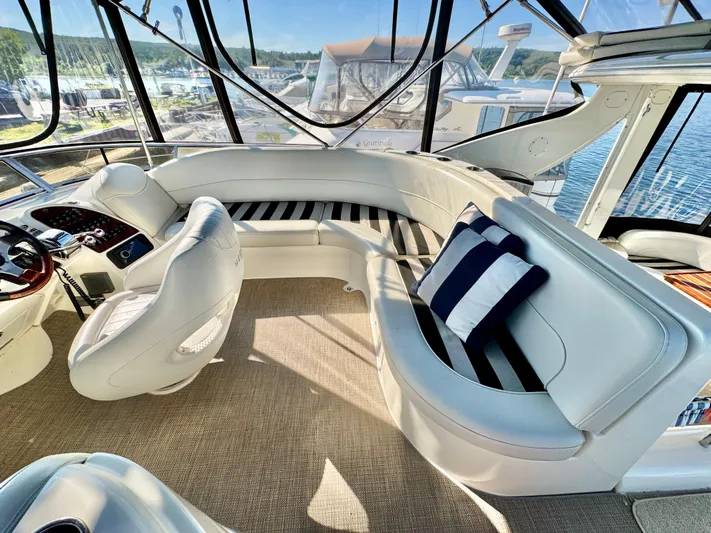  Yacht Photos Pics Luxurious 2005 Meridian 459 CMY yacht interior with plush seating and striped cushions.