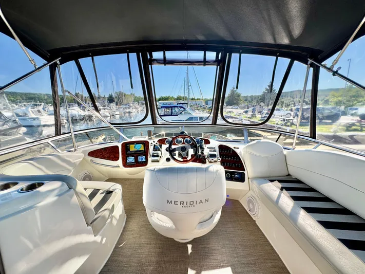  Yacht Photos Pics Interior view of 2005 Meridian 459 CMY yacht cockpit with marina background.
