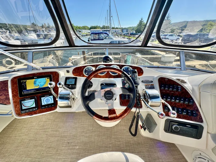  Yacht Photos Pics Cockpit of 2005 Meridian 459 CMY yacht with navigation controls and steering wheel.