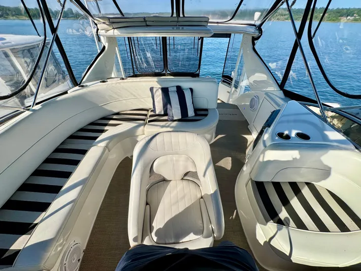  Yacht Photos Pics Luxurious 2005 Meridian 459 CMY yacht interior with striped seating and panoramic windows.