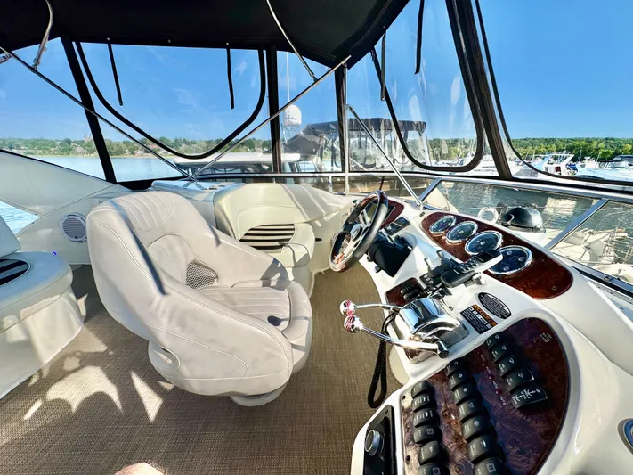 Yacht Photos Pics Helm of 2005 Meridian 459 CMY yacht with luxurious seating and control panel.