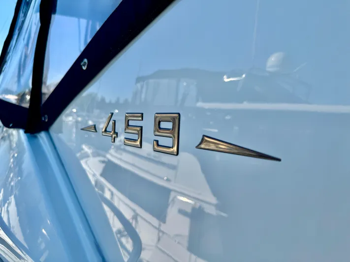  Yacht Photos Pics Close-up of 2005 Meridian 459 CMY yacht emblem on reflective surface.