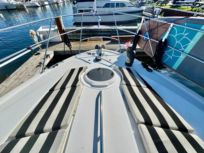  Yacht Photos Pics 2005 Meridian 459 CMY yacht with striped deck cushions docked at marina.