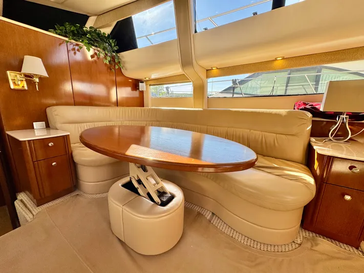  Yacht Photos Pics Luxurious interior of 2005 Meridian 459 CMY yacht with elegant seating and wooden table.
