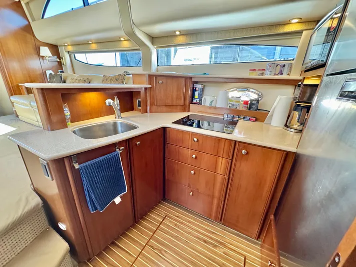  Yacht Photos Pics Luxurious 2005 Meridian 459 CMY yacht kitchen with wood cabinetry and modern appliances.